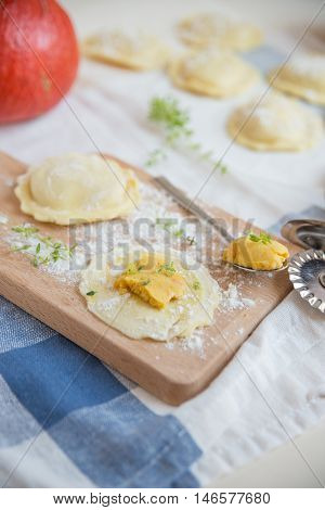 homemade stuffed with pumpkin ravioli on a wooden board