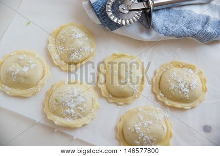 homemade stuffed with pumpkin ravioli on a wooden board