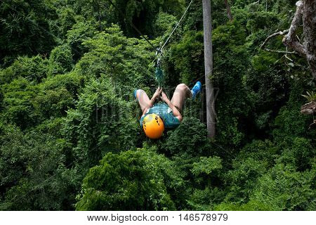 A woman having fun doing extreme sport zip line