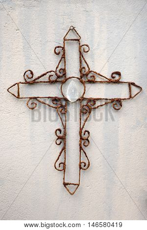 Rusty Wire Cross Against Wall