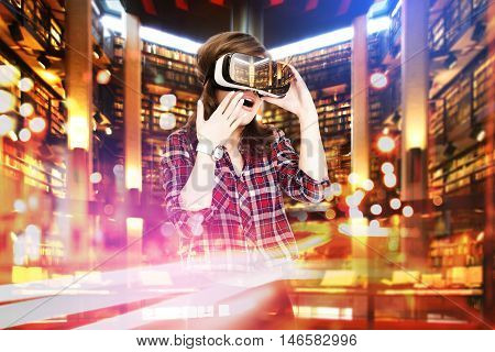 Double exposure, young girl getting experience VR headset, is using augmented reality glasses, being in a virtual actuality. In the library