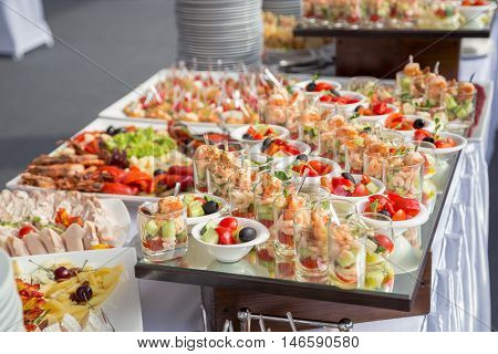 Banquet Table in restaurant served with different meals. Ready for wedding reception.