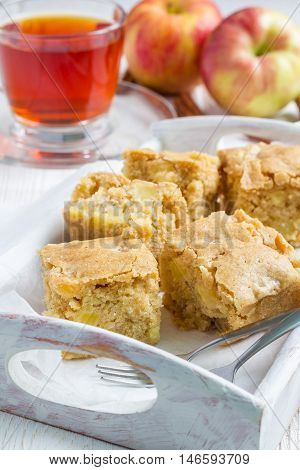 Homemade blondie (blonde) brownies apple cake square slices in wooden tray vertical