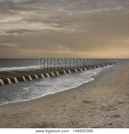 The beach looks like keys of a piano. Sea waves make music on the them.