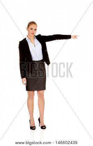 Angry business woman shows get out gesture