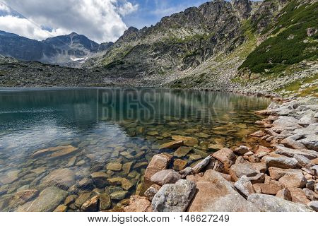 Stones in the water and reflection of Musalenski lakes,  Rila mountain, Bulgaria