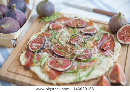 freshly baked French Flammkuchen with figs and cheese