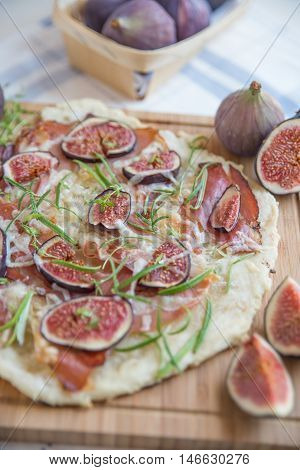 freshly baked French Flammkuchen with figs and cheese