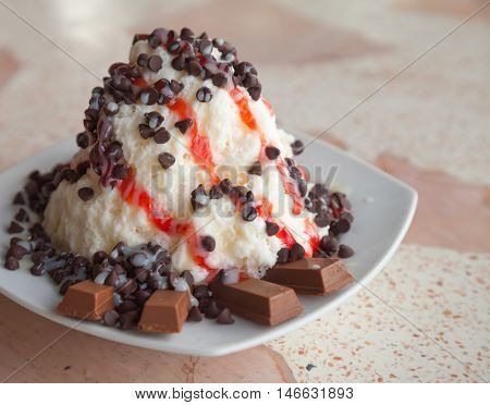 snow ice cream made from yogurt and chocolate topping. delicious dessert.
