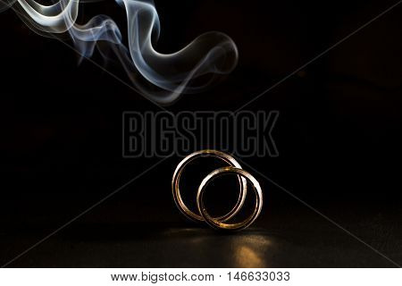 wedding rings on the background of smoke