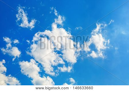 Clouds in blue sky. Blue sky with white fluffy cumuli clouds.