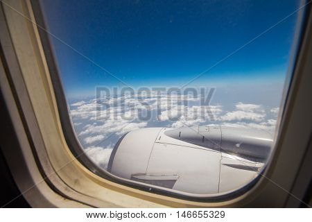 Clouds and sky as seen through window of an aircraft
