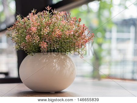 Decorative flower on the wood table in the morning
