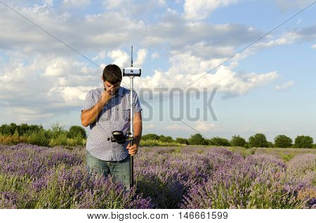 Lavender field and surveyor in horizontal shot