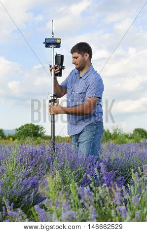 Geodesy work in a lavender field in countryside