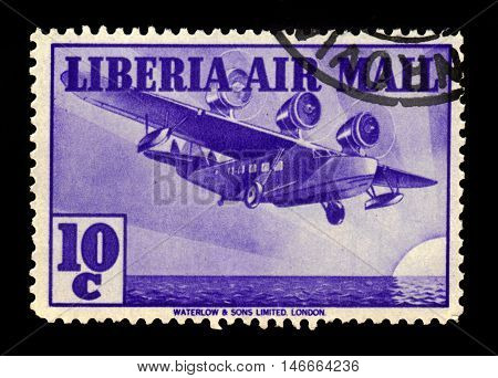 Liberia - CIRCA 1938: A stamp printed in Liberia shows three-engine aircraft over the ocean, circa 1938