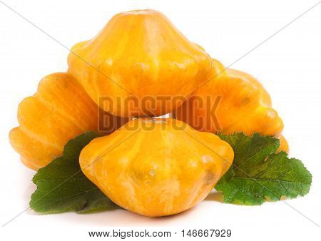 four yellow pattypan squash with leaf isolated on white background.