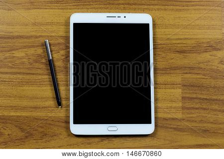 White Tablet. Tablet pc on wooden table.