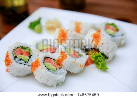 Rolls With Salmon, Avocado And Caviar Over White Background