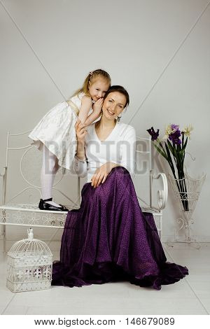 young mother with daughter at luxury home interior vintage, old fashion relashionship family