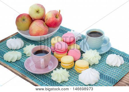 Still life of served coffee cups macaroon cookies marshmallows and apples