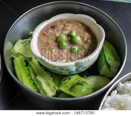 Chili shrimp paste sauce Thai style and fresh vegetable in food carrier Thai style
