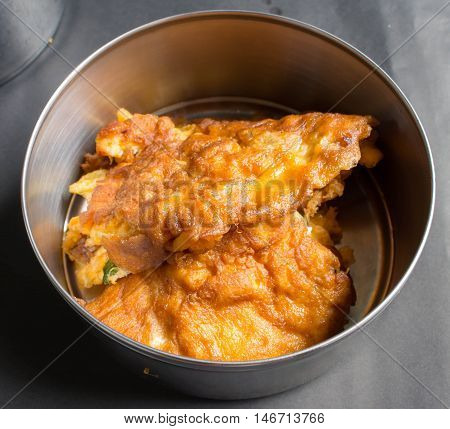 Thai Omelette in a part of aluminium food carrier Thai style