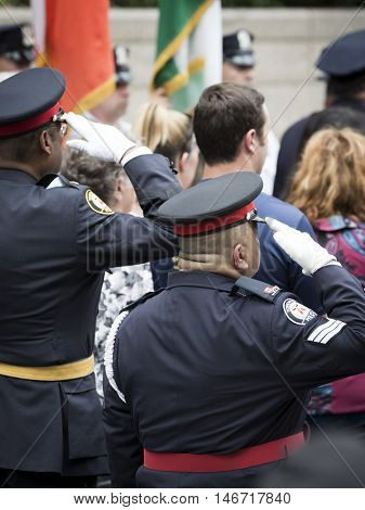 NEW YORK - SEPT 9 2016: Police officials from Toronto Canada salute at the NYPD Emerald Society Pipe and Drums 9/11 Memorial Commemoration Service marking the 15th anniversary of the terror attacks.