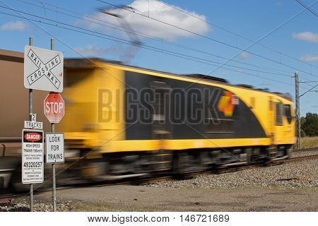 GLADSTONE, AUSTRALIA - September 2: An Aurizon coal train passes by a level crossing in the Gladstone region on Friday, 2nd September, 2016.
