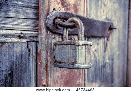 lock and forged curtain on a wooden door