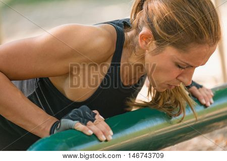 Female athlete doing push-ups, color image, close up