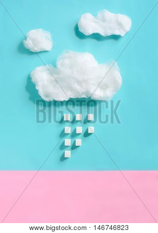 Sugar concept clouds made of cotton candy with sugar rain falling