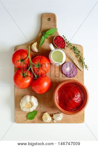 Ketchup or tomato sauce ingredients on a cooking board concept background