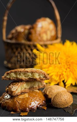 Typical Dutch filled spicy cookies with almonds on autumn colored and dark background