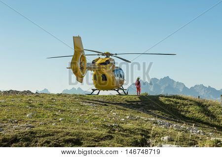 Yellow helicopter used for rescue operations, On the ground in Dolomites, Italy. Helicopter rescue