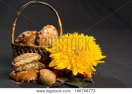 Typical Dutch filled spicy cookies with almonds on autumn colored and dark background