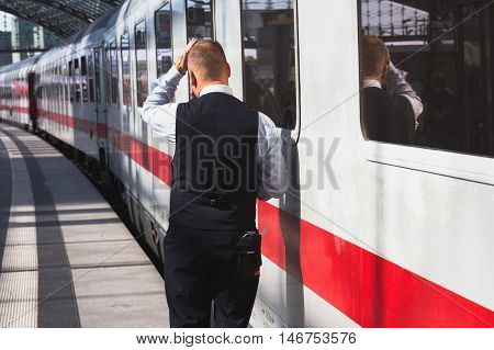 Berlin Germany - September 9 2016: Train conductor from behind standing in front of ice train at central staion in Berlin.