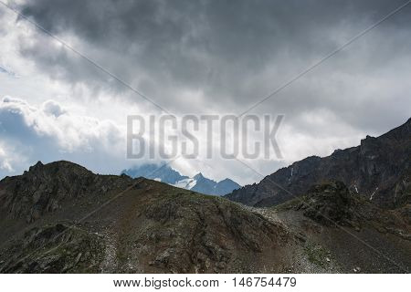 mountain under sky with dramatic clouds