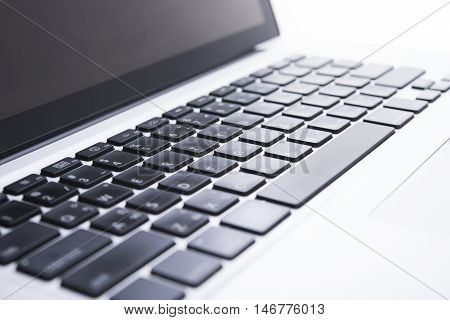 Close up computer keyboard on desktop office of a modern laptop.