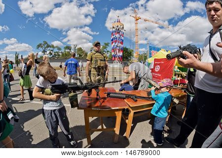 Boy Takes Aim With A Machine Gun