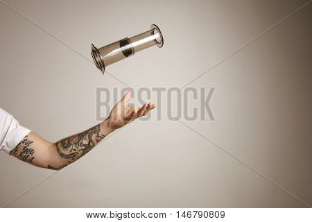 Tattoed Man's Arm Throwing And Catching Aeropress