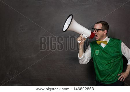Funny retro nerd yelling through the megaphone with copy space