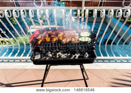 Delicious Meat On Barbecue Grill With Coal On Balcony.