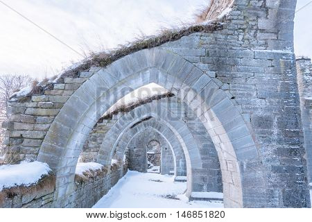 Alvastra Monastery ruins a arch way in winter