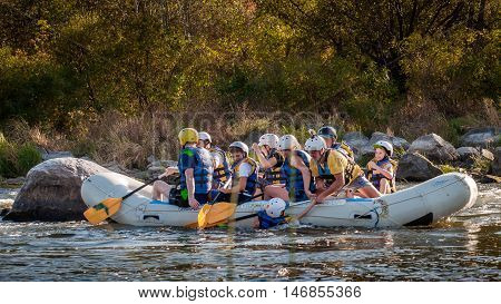 Village Mygiya, Nikolaev region, Ukraine - September 10, 2016: Rafting on the Southern Bug River. An experienced instructor holds the key to a great adventure. Rafting in Ukraine. Risky, bold action.