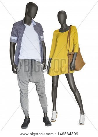 Two mannequins male and female dressed in casual clothes. Isolated on white background. No brand names or copyright objects.