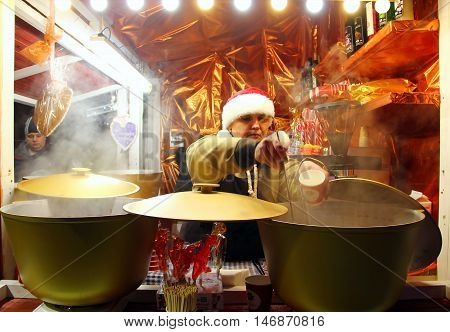 KYIV, UKRAINE - DECEMBER 20, 2015: Woman sell mulled wine at traditional Christmas market on Sophia Square in Kyiv