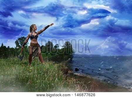Athletic female in the image of the ancient Princess of the barbarians performing a magical ritual invocation of the spirit of the storm.