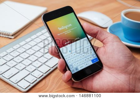 CHIANG MAI, THAILAND - JANUARY 02, 2015.Hand holding Iphone and using Instagram application. Instagram is largest and most popular photograph social networking site in the world