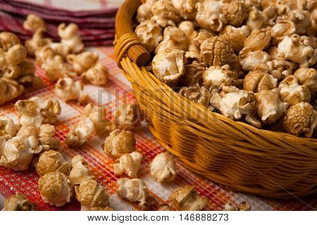 caramel popcorn in a basket on a napkin close up